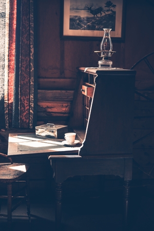 Vintage Wooden Desk in the Dark Room. Early XX Century Room Interiorの写真素材