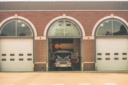 Firefighters of Colorado. Fire Truck inside Firehouse. Large Colorado Flag on the Wall. Colorado Fire Department.の写真素材