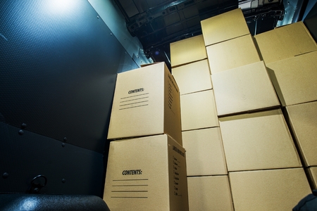 Pile of Boxes in a Cargo Van Closeup. Products Transportation Industry. Shipping and Delivery.の写真素材