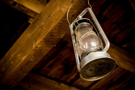 Oil Lamp Hanged in the Wooden Barn. Vintage Lantern Closeup.の写真素材