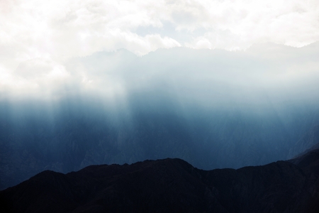 Light Through the Clouds. Scenic Mountain Sun Rays Coming Through the Clouds. California, United...