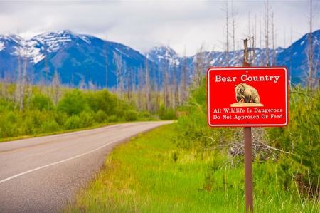 Bear Country Warning Sign. All Wildlife is Dangerous. Do Not Approach or Feed Red Countryside Sign. Montana, United States.の写真素材