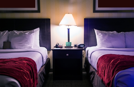 Hotel Room Interior at Night. Two Queen Size Beds in Hotel Room.