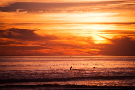 Surfers and the Ocean. Southern California Ocean Sunset with Surfers Awaiting Big Wave.の写真素材