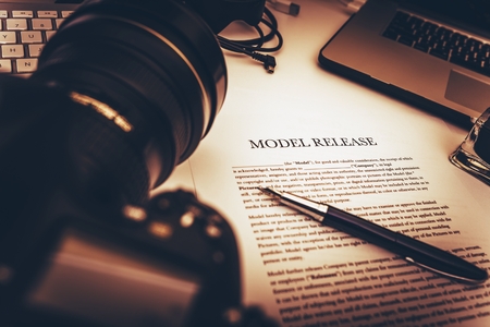 Model Release Signing Photo Concept. Model Release Document and Photo Equipment on a Desk.の写真素材