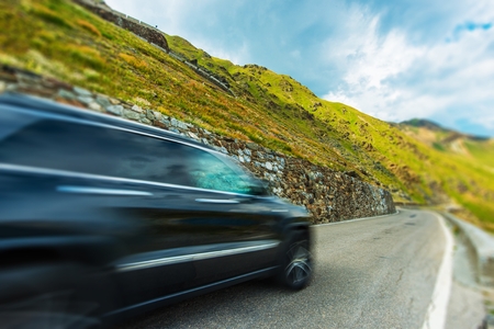 Mountain Road Fast Driving. Modern Sport Utility Vehicle on the Italian Stelvio Pass.の写真素材