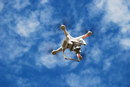 Flying Small Toy Drone on the Cloudy Sky. Drone Technology.