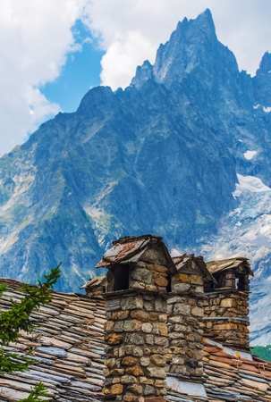 Vintage Italian Alp Architecture. Rocky Roof and Chimneys. Italian Alpine Vintage Style.の写真素材