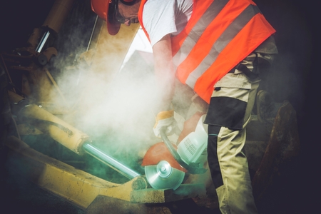 Construction Men Job. Caucasian Men with Stone Cutter at Work.の写真素材