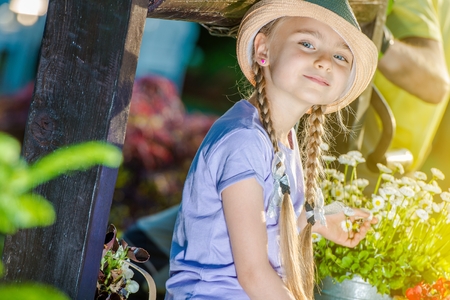 Happy Caucasian Girl in the Garden Having Fun During Summer Time. Girl with Braids.の写真素材