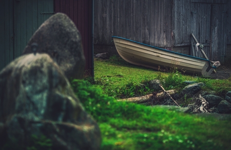 In the Norway Village. Theme with a Boat and the Wooden Barn. Norway Place.の写真素材