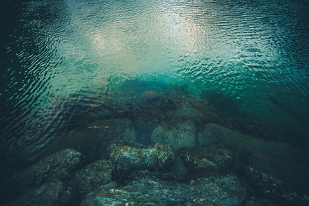 Deep Fjord Rocky Shore. Crystal Clear Norwegian Fjord Water.の写真素材