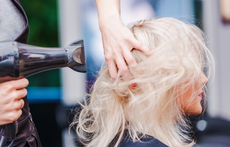 Hairdresser Business. Beauty Studio Hairstylist Air Blowing Clients Hair.の写真素材