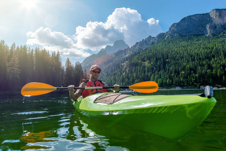 Caucasian Sportsman Kayaking on the Scenic Lake. Italian Dolomites, Lake Misurina, Europe.の写真素材