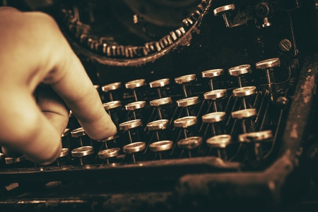 Typing on Aged Vintage Typewriter. Closeup Photo. Vintage Writer.の写真素材