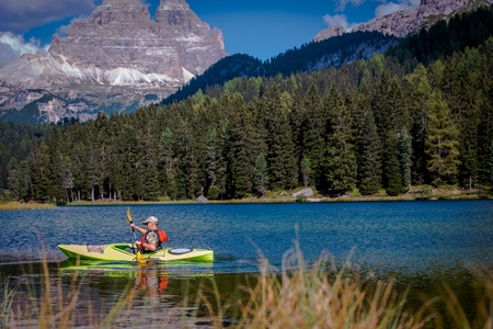 Scenic Mountain Lake Kayak Tour. Caucasian Men in the Kayak.の写真素材
