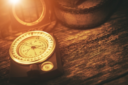 Vintage Journey Compass Concept Photo. Aged Compass on the Old Wooden Table.の写真素材