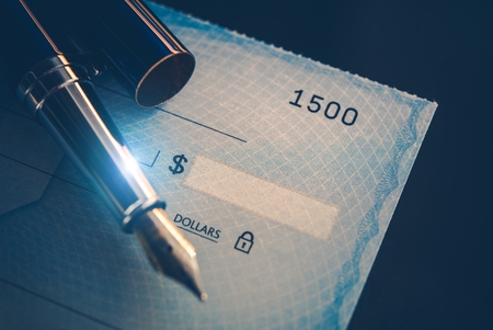 Writing Check Payment Using Elegant Fountain Pen. Executive Desk Business Concept. Corporate Paycheck.の写真素材