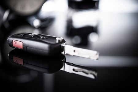 New Car Keys Closeup. Brand New Vehicle Purchase Concept. Dealership Sale Desk.の写真素材