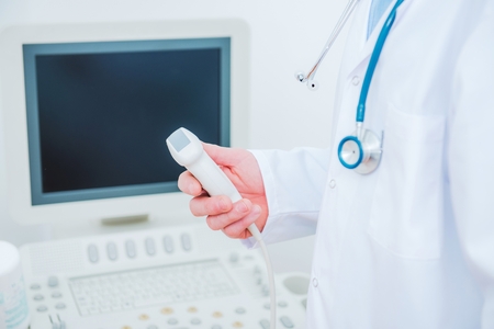 Medical Doctor with the Ultrasonography Device in a Hand.
