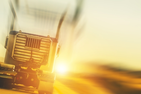 Trucking and Transport Concept Photo Background. Truck on the Highway During Sunset.の写真素材
