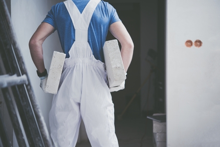Construction Worker Job. Caucasian Worker Moving Building Materials in His Hands.の写真素材