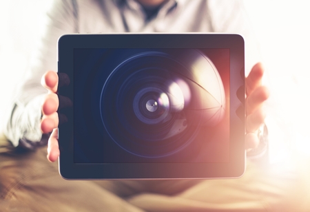 Photography is the Choice Concept Photo. Men with Tablet Device Displaying Photography Lens on the Screen.の写真素材