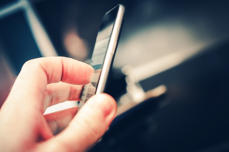 Daily Mobile Device Using. Mobiles Applications and Internet on the Go Photo Concept.の写真素材