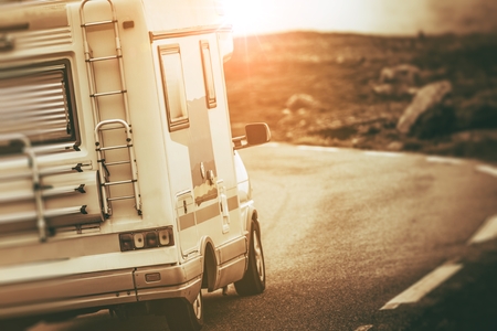 Camper Van on the Scenic Mountain Road. RV Motorhome Traveling Concept. Sepia Color Grading.の素材 [FY31076663838]