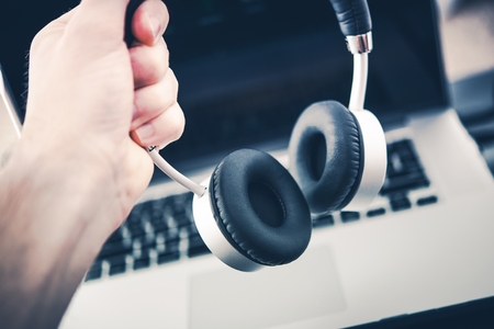 Wireless Stereo Headphone Set and the Laptop Computer. Computer Music Listening.の写真素材