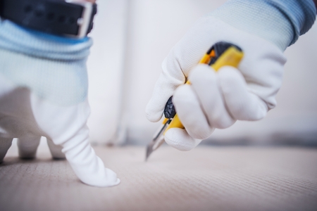 Paper Cutting by Knife Closeup Photo. Preparing Pieces of Paper To Cover Before Painting.の写真素材