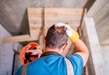 Worker Wearing Hard Hat in the Construction Site. Safety Equipment.