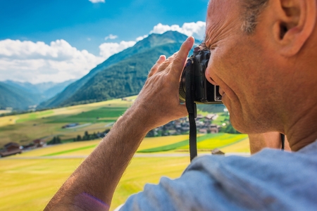 Vacation Photo Memories. Caucasian Men in His 50s Taking Pictures on His Vacation Trip.の写真素材