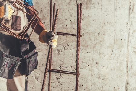 Steel Reinforcement Worker with Rebar Steel Bars Ready To Use. Construction Materials and Technologies.の写真素材