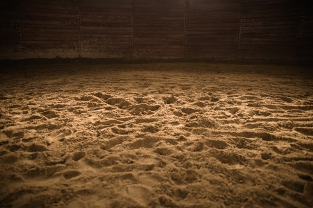 Sandy Horse Riding Arena with Light Spot in the Middle. Rodeo Photo Background.の写真素材