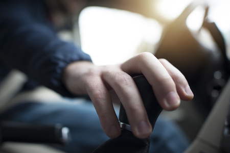 Driving with Hand on a Stick Shift. Closeup Photo. の写真素材