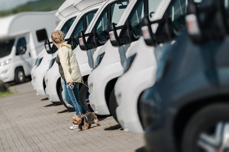 Caucasian Woman Buying New Camper Van. Looking Around To Find the Perfect Camper on the Dealership...