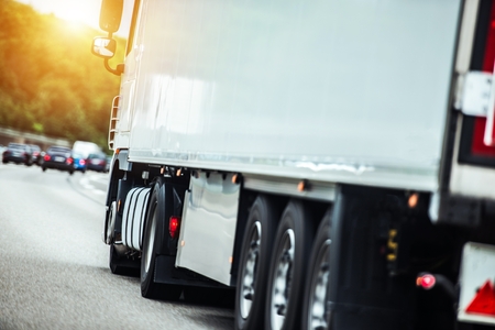 Semi Truck on the Route To Delivery Destination. Speeding Truck on a Highway.の写真素材