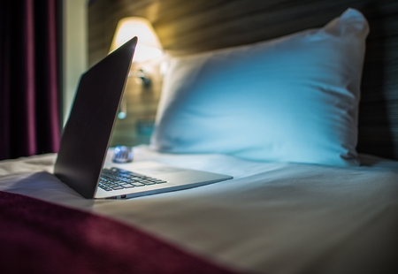 Night Time Internet Browsing. Modern Laptop Computer on the Bed. Browsing Network Before Sleep. Sleepless Night Concept.の写真素材