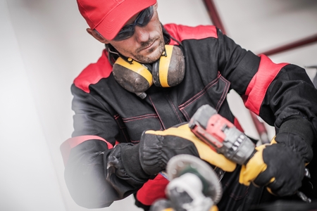 Caucasian Construction Worker in His 30s with Power Drilling Tool.の写真素材