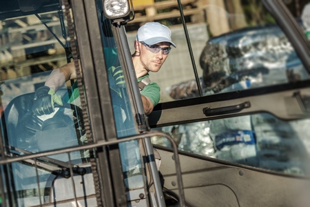 Forklift Worker in Action. Closeup Photo. の写真素材