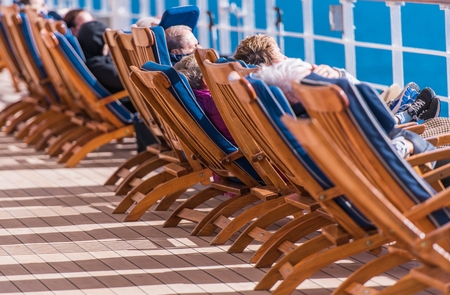 Sea Travel and Cruise Ship Relax. People Relaxing on Deckchairs During Transatlantic Cruise.の写真素材