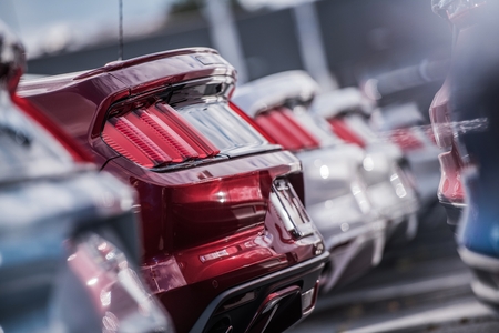 Cars Industry Dealer Concept. New Delivered Cars on the Dealership Sales Lot. Transportation Theme.の写真素材