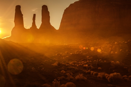 Scenic Monument Valley Sunset with Last Rays of the Sun Covering Raw Arizona Desert. United States of America.の写真素材