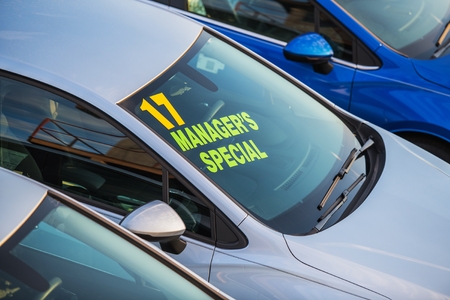 Brand New Vehicle with Managers Special Sign on a Windshield. Car Dealer Lot.の写真素材