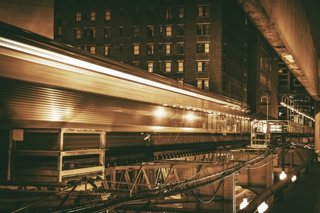 Downtown Chicago Speeding Train in Long Exposure Photography. Dark Sepia Color Grading. Chicago Urban Theme,の写真素材