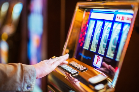 Casino Gambling Industry Theme. Caucasian Woman Playing Classic Slot Machine in the Casino.