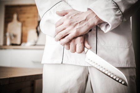 Italian Master Chef with Huge Kitchen Knife Getting Ready For Work. の写真素材