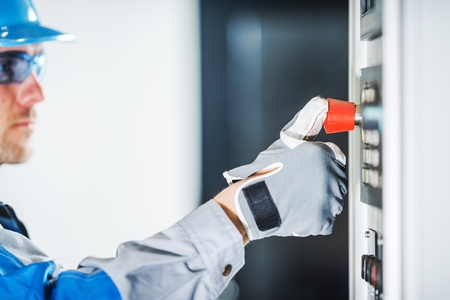 Emergency Machine Stop Button. Caucasian Engineer Testing Red Emergency Stop.