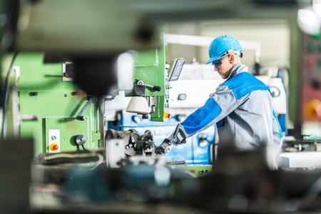 CNC Metal Lathe Technician Worker. Caucasian Contractor Operating Heavy Duty Metalworking Machinery.